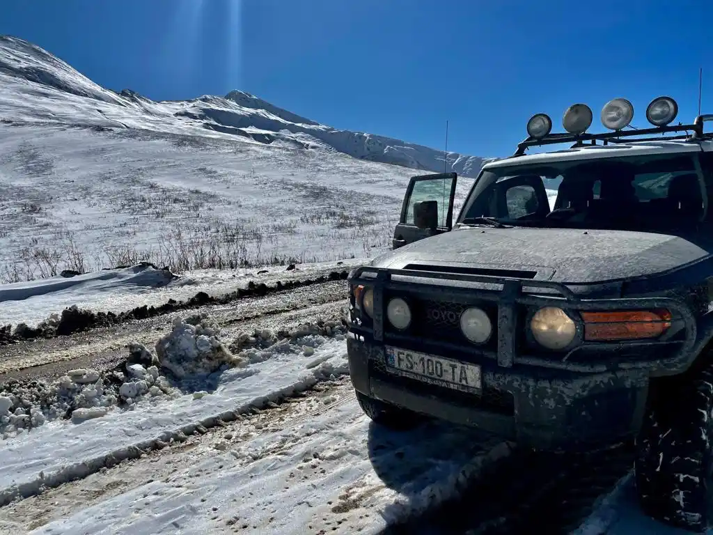 our 4x4 rental car on a snowy mountain road